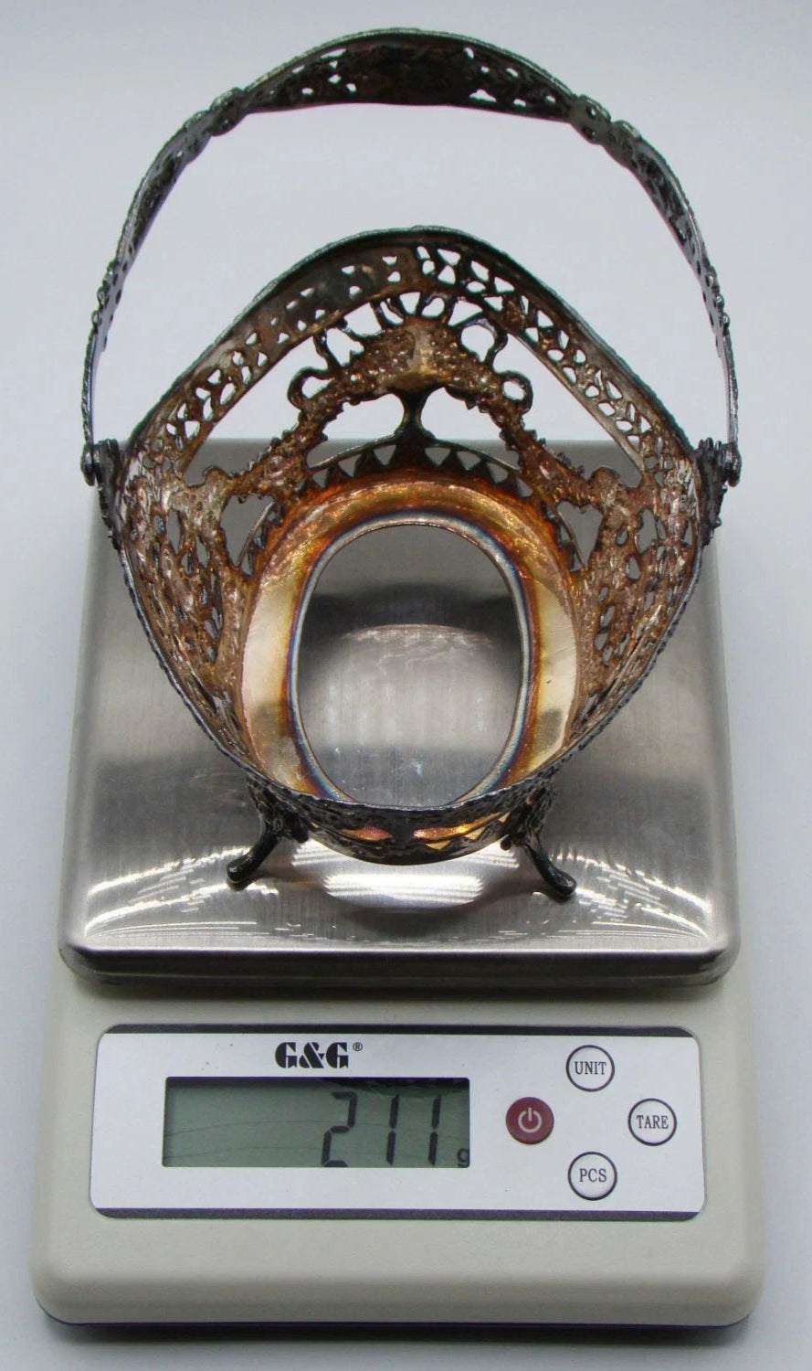 Close-up of stamped marks on the inside of the silver basket handle.