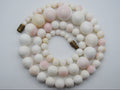 1930s White Angel Skin coral necklace arranged in a coil, showing graduated white and blush-pink beads