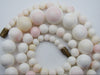 Alternate overall view of the graduated coral necklace with its barrel screw clasp open