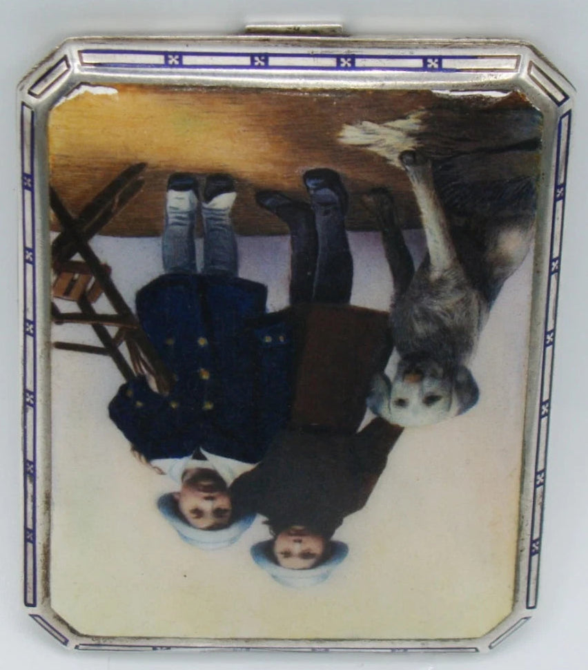 Inverted view of the children and dog panel showing the silver case rim and closure tab.