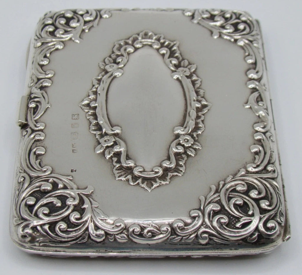 Alternate view of the silver cigarette case showing scrolling corner decoration, cartouche and stamped marks.