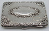 Decorated silver case panel with an oval cartouche, engraved dedication and dates, with visible surface wear.