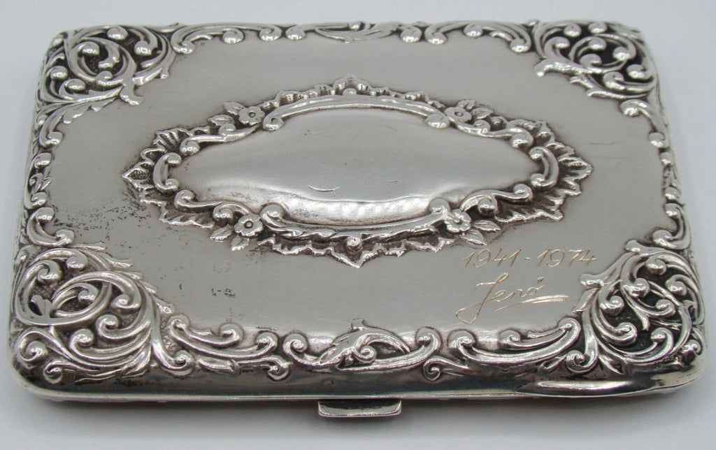 Decorated silver case panel with an oval cartouche, engraved dedication and dates, with visible surface wear.