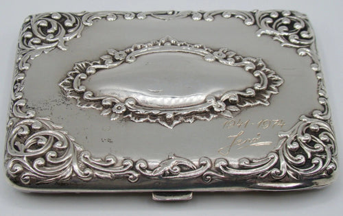 Decorated silver case panel with an oval cartouche, engraved dedication and dates, with visible surface wear.