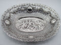 Overall view of an oval Baroque-style 800 silver tray with cherub relief and pierced floral borders
