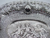 Upper border detail showing floral garlands, pierced silverwork and an oval cartouche