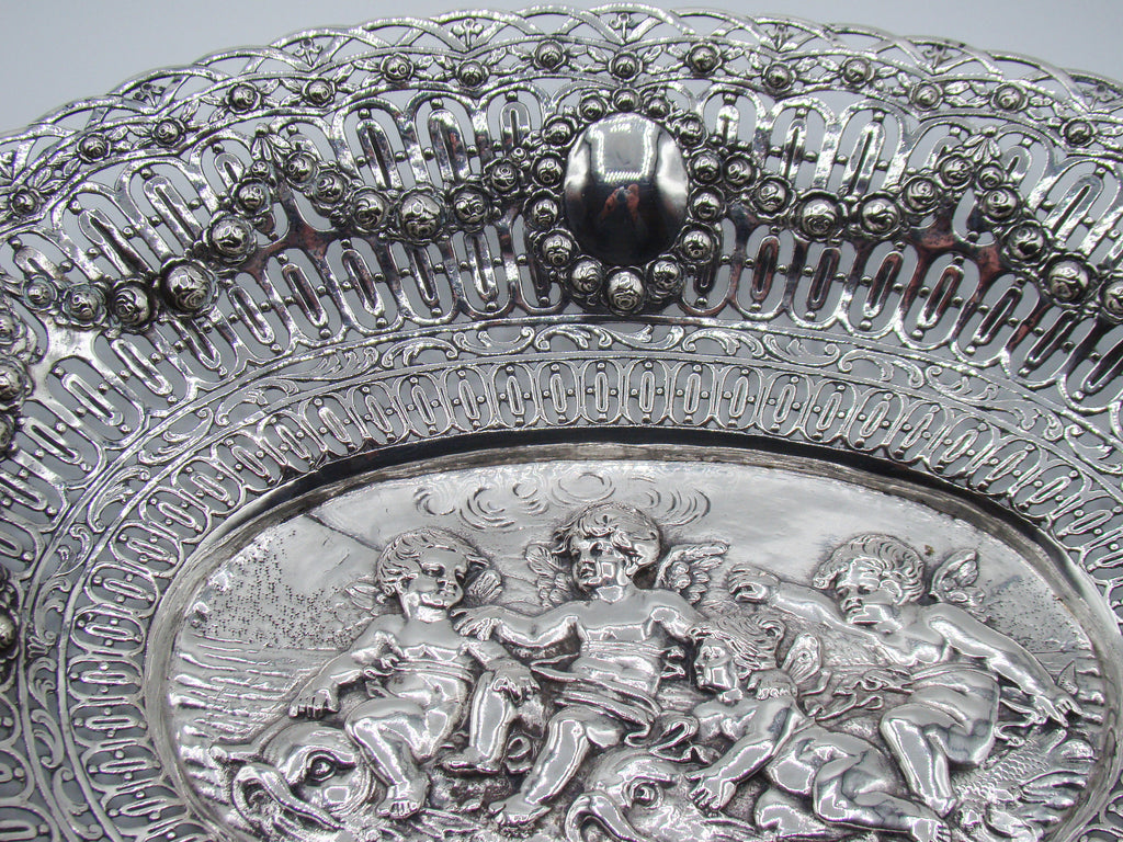 Upper border detail showing floral garlands, pierced silverwork and an oval cartouche