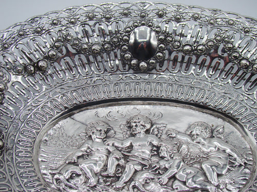 Upper border detail showing floral garlands, pierced silverwork and an oval cartouche