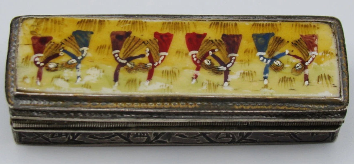 Opposite side view of the closed silver box showing the decorated lid and engraved sides