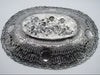 Underside of the silver tray showing the reverse of the relief and pierced border