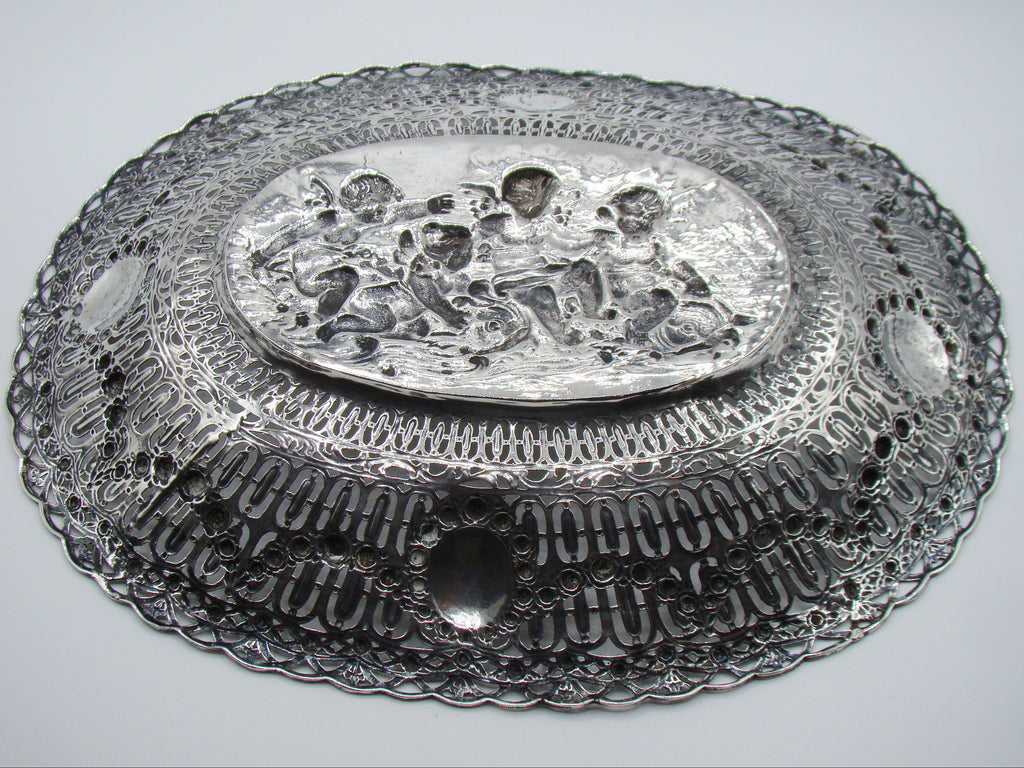 Underside of the silver tray showing the reverse of the relief and pierced border