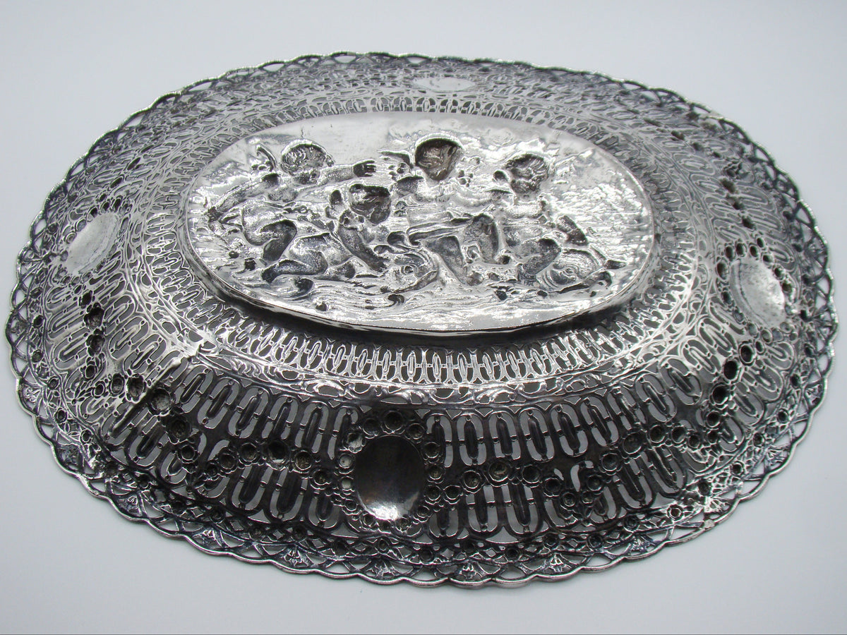 Underside of the silver tray showing the reverse of the relief and pierced border