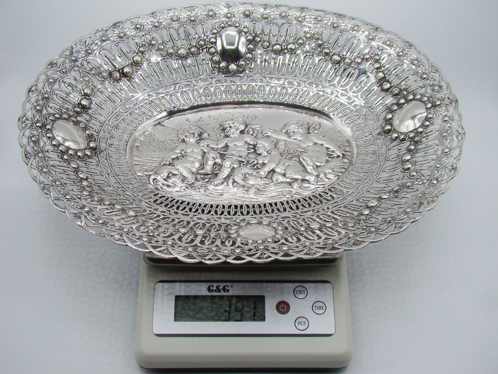 Oval silver tray on a digital scale displaying 391 grams