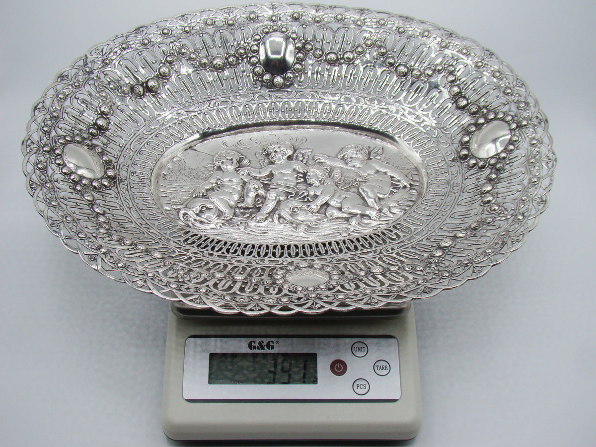 Oval silver tray on a digital scale displaying 391 grams