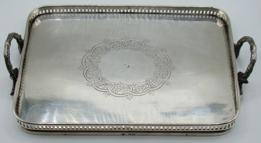 Ottoman-attributed rectangular silver tray with two ornate handles and engraved central floral wreath
