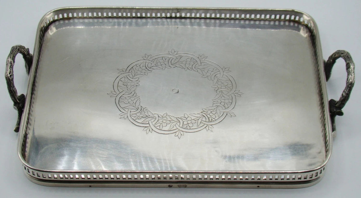 Ottoman-attributed rectangular silver tray with two ornate handles and engraved central floral wreath
