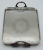 Full view of the silver tray showing the pierced gallery and floral engraving
