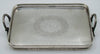 Silver tray with two decorative loop handles viewed lengthwise