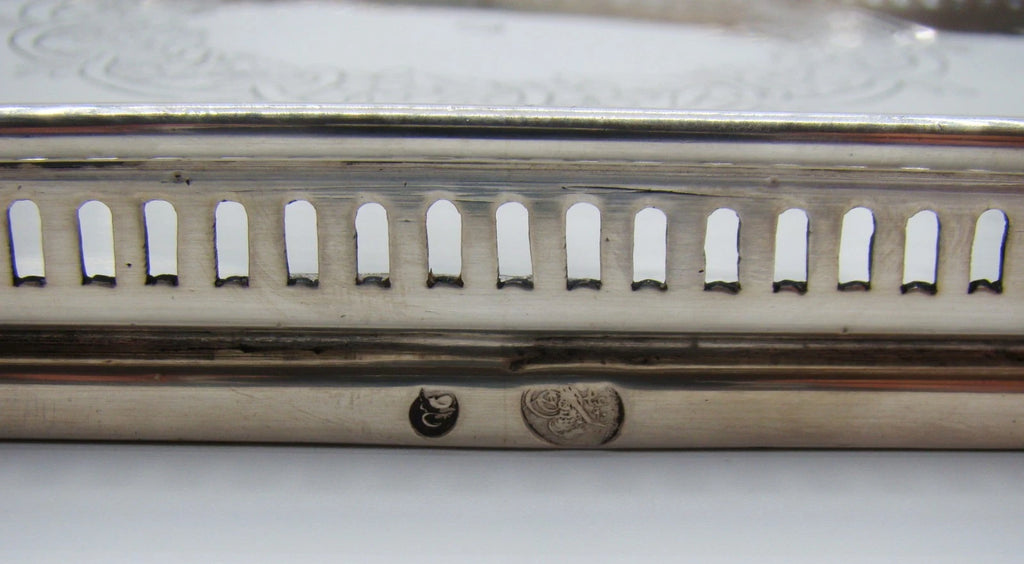 Close-up of the engraved floral wreath and small irregular central mark