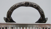 Detail of an ornate textured loop handle and its leaf-shaped attachments