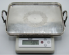 Two-handled silver tray on a digital scale displaying 504 grams