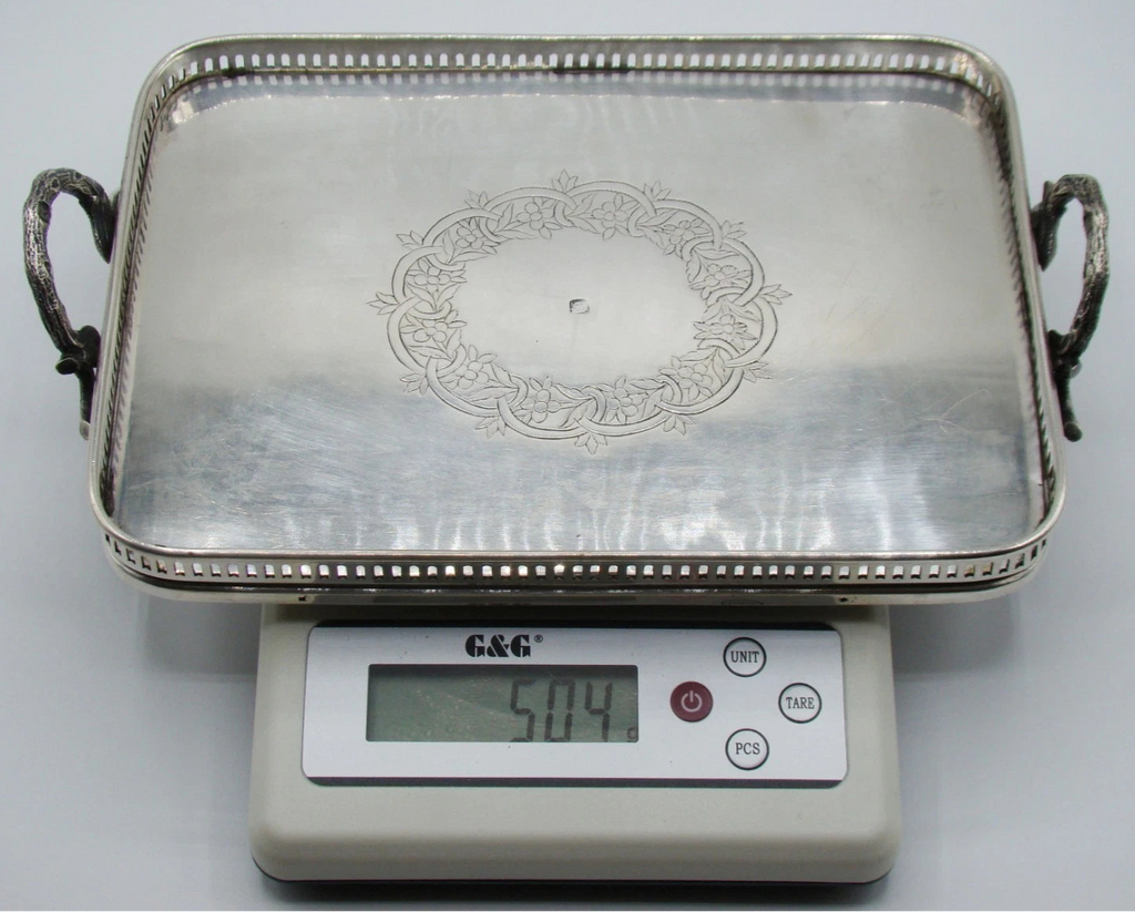 Two-handled silver tray on a digital scale displaying 504 grams