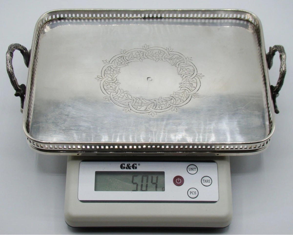Two-handled silver tray on a digital scale displaying 504 grams