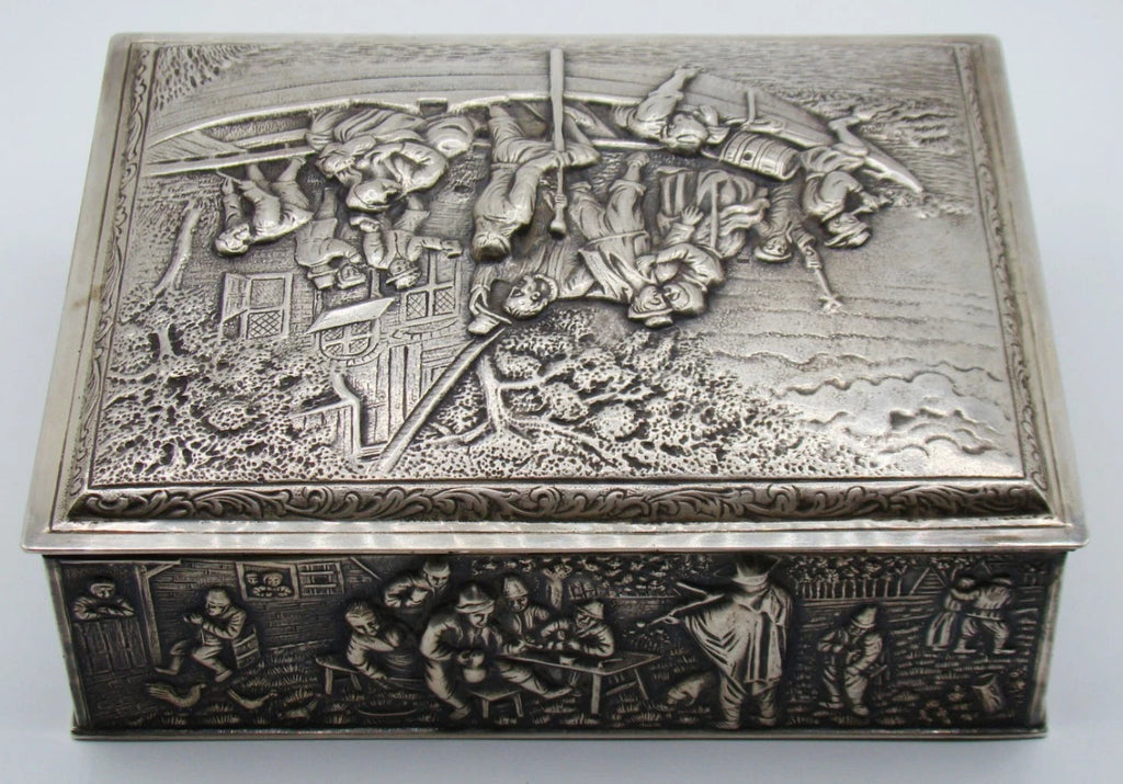 Opposite side of the silver box with tavern figures in relief and the decorated lid above.