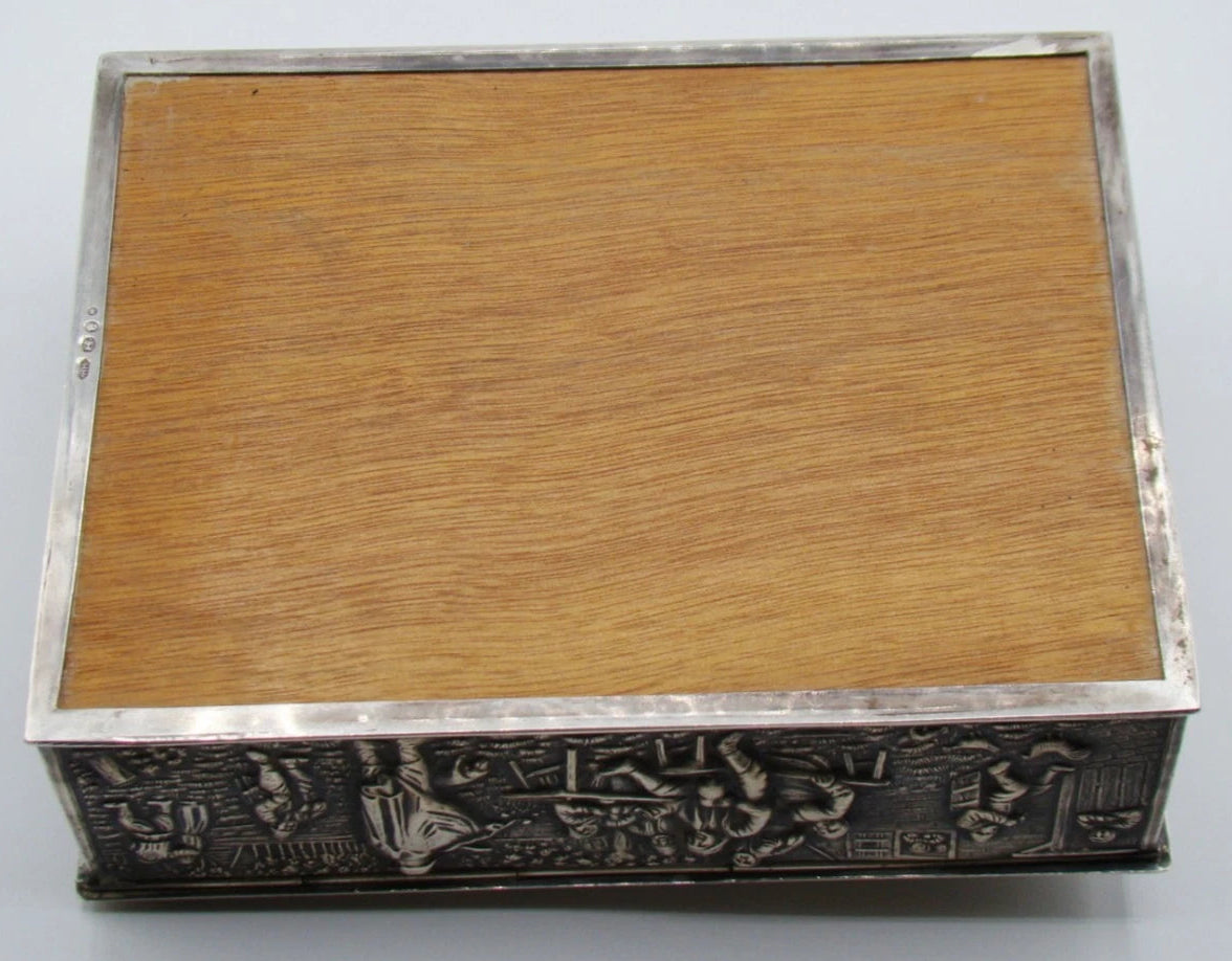 Wooden underside panel surrounded by the silver rim of the rectangular box.