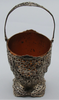 800 silver openwork basket with raised swing handle, shaped foot, and copper-coloured removable insert.
