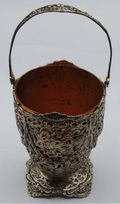 800 silver openwork basket with raised swing handle, shaped foot, and copper-coloured removable insert.