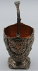 Angled view of the silver basket showing its decorated handle and pierced foliate body with insert.
