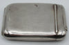 Plain reverse of the silver cigarette case showing surface marks and the narrow compartment hinge.