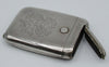 Silver monogrammed cigarette case with the narrow side compartment open.
