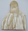Close-up of the carved clerical portrait's face and textured beard in mother-of-pearl