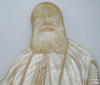 Inverted view of mother-of-pearl portrait showing robe folds, cross and carved chain