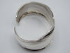 Rear view of the silver cuff bracelet showing the open gap, smooth interior, and bordered ends.