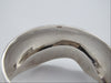 Close-up of the 925 stamp inside the silver cuff bracelet, with visible surface scratches.