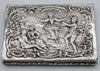 800 silver rectangular box with pastoral relief scene, a figure on a swing, and floral scrollwork border.