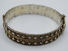 Rear view of the decorated silver bangle showing its hinge and twisted-wire horizontal bands.