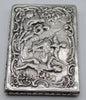 Close view of the silver box showing the figurative relief, flowers, and beaded edge.