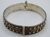 Side view of the silver bangle showing raised faceted metal accents and discolouration inside.
