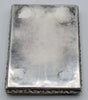 Plain underside of the silver box showing scratches and patches of discolouration.