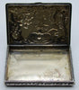 Open silver box showing its plain interior and the reverse of the relief-decorated lid.