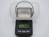 Silver hinged bangle on a digital scale displaying 41.8 grams.