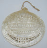 Angled view of carved Last Supper shell showing Christ and apostles within a scrolling floral border