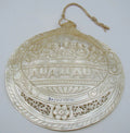 Angled view of carved Last Supper shell showing Christ and apostles within a scrolling floral border