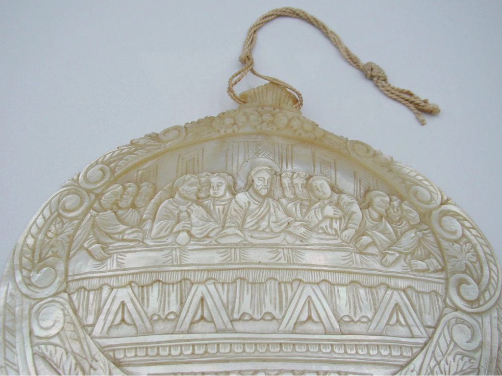 Opposite angled view of mother-of-pearl Last Supper carving and pierced lower border