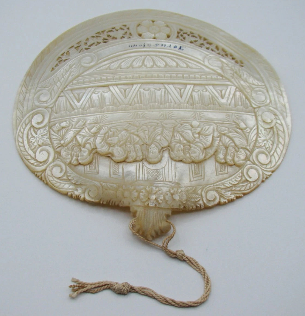 Front view of mother-of-pearl Last Supper shell with Jerusalem inscription, floral openwork and attached cord