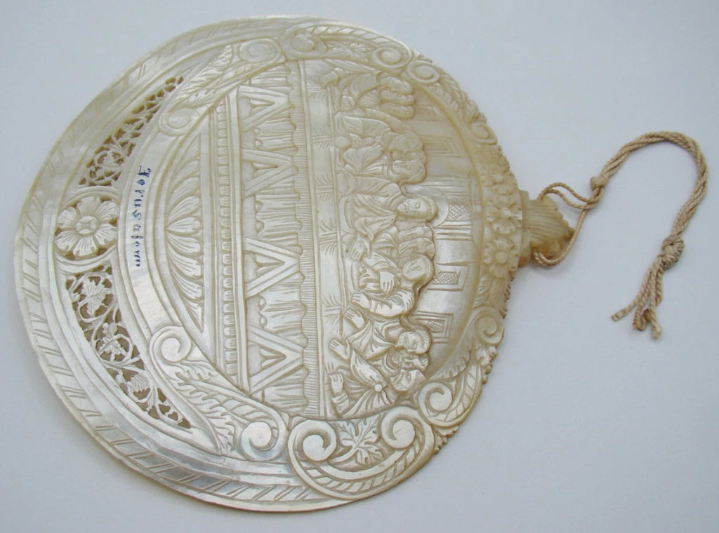 Reverse of mother-of-pearl Last Supper shell showing curved surface and pierced ornament